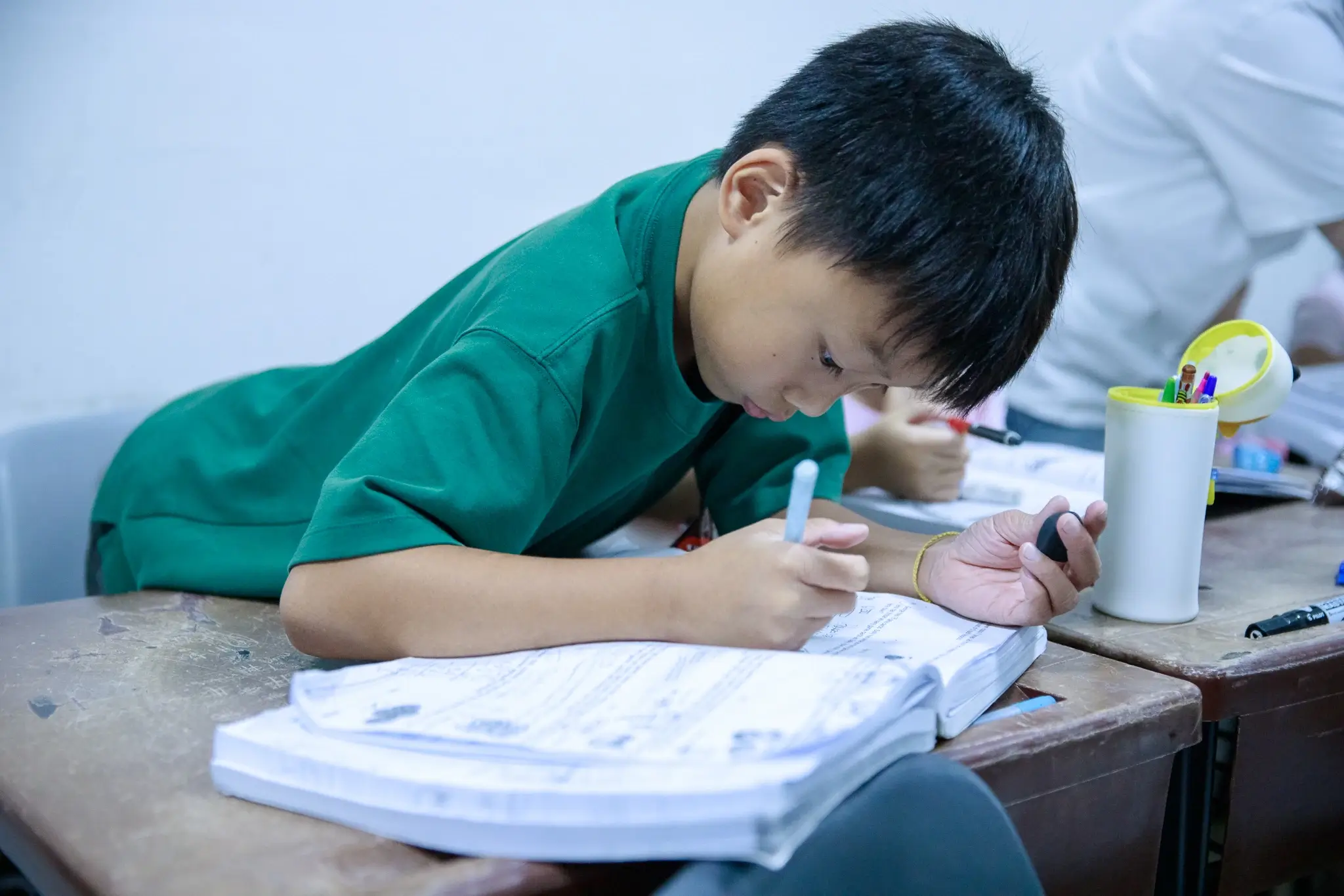 A child is studying alone
