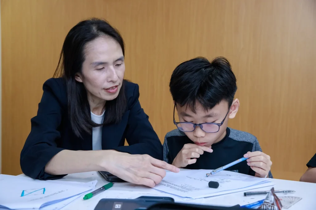 A student is studying with teacher at a tuition centre